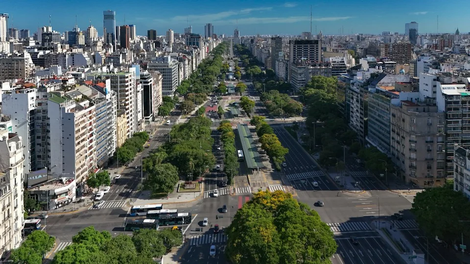 View of a Buenos Aires avenue from a high balcony, showing buildings and the urban landscape.