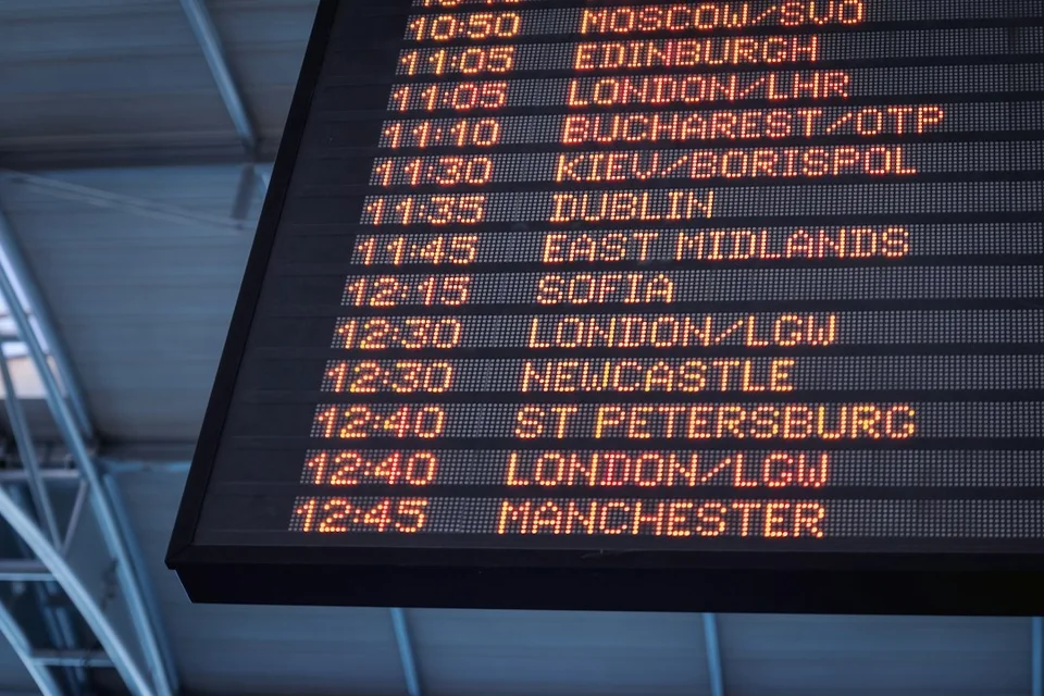 Airport departures board showing international destinations including Moscow, Edinburgh, London, Dublin and Manchester.